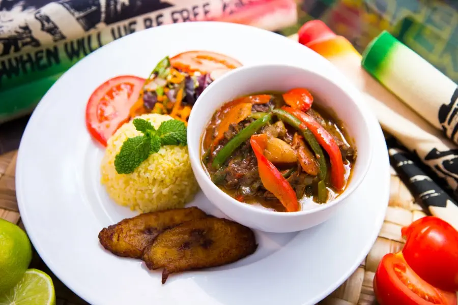 best time to travel to Jamaica and how to prepare - blog - Jamaican cuisine - fried plantain, rice, vegetables, and stewed beef